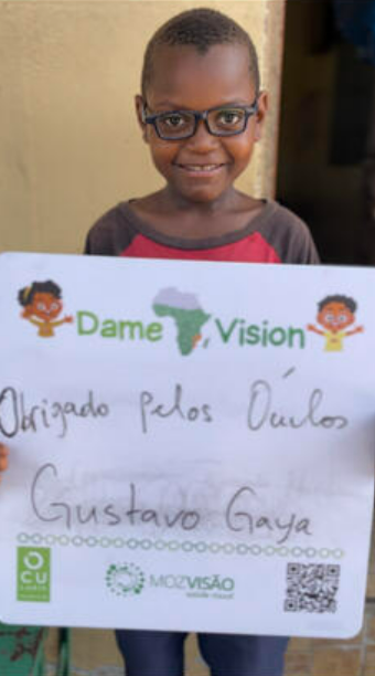 Niño con gafas que sostiene un cartel de agradecimiento de DameVision